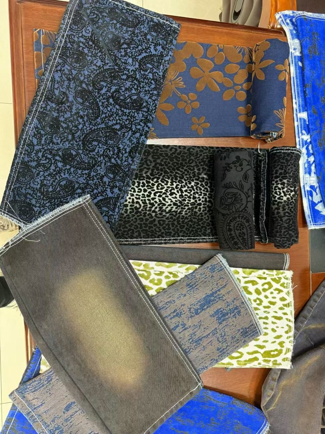 Flocked denim fabric swatches showing floral leopard and textured surface options
